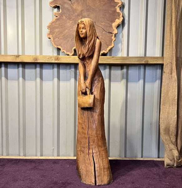 A 4 ft sculpture of a girl holding a handbag