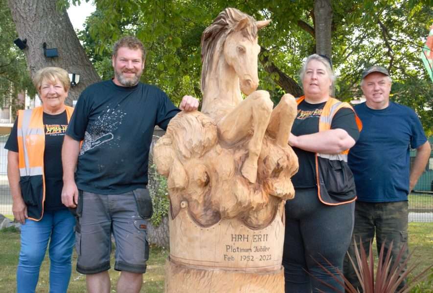Photo of a horse sculpture by simon o'rourke with two people either side, including simon o'rourke. they are the working group who arranged the commission and installation and the photo links to the working group section of simon's blog about steps to commisioning a unique community sculpture