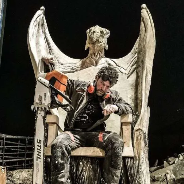 Simon O'Rourke in a wooden chair